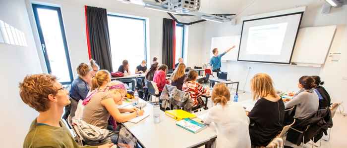 AUC class in progress, students seated with teacher in the front