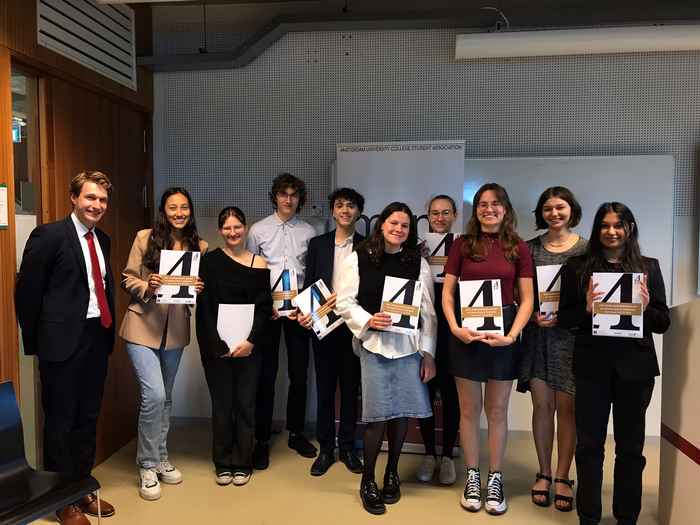 InPrint students holding the latest version of the journal
