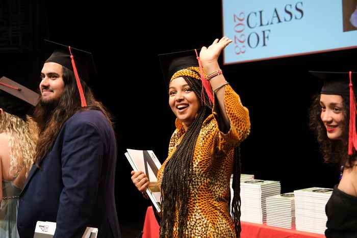 AUC student waving to the audience