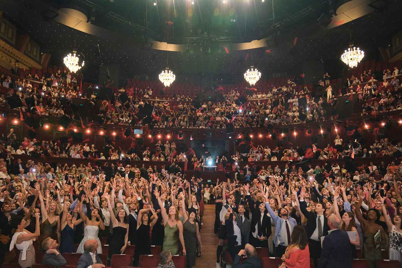 View on students throwing hats at Carré