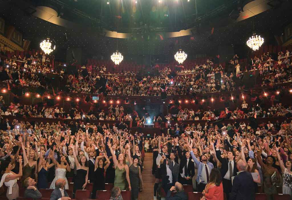 View on students throwing hats at Carré