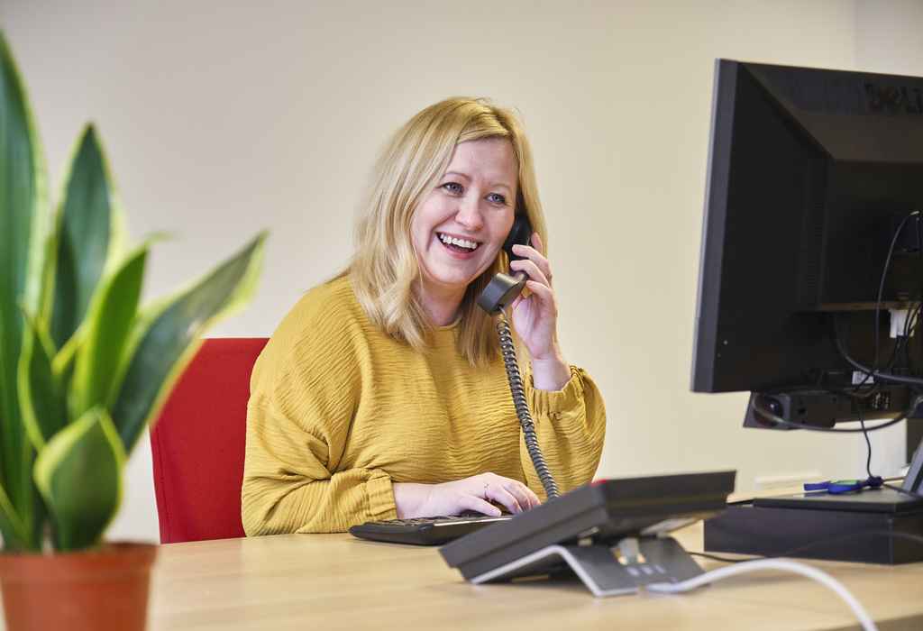 Admissions colleague working behind a desk