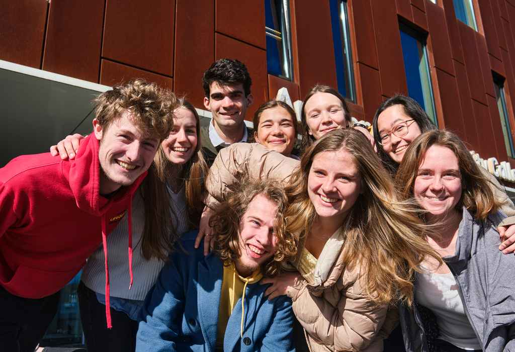 Group of AUC students on stage at AUC building