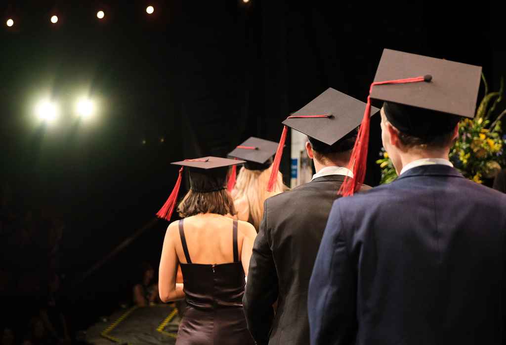 AUC graduates with hats