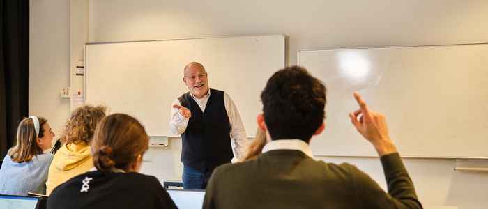 AUC class in progress, students seated with teacher in the front